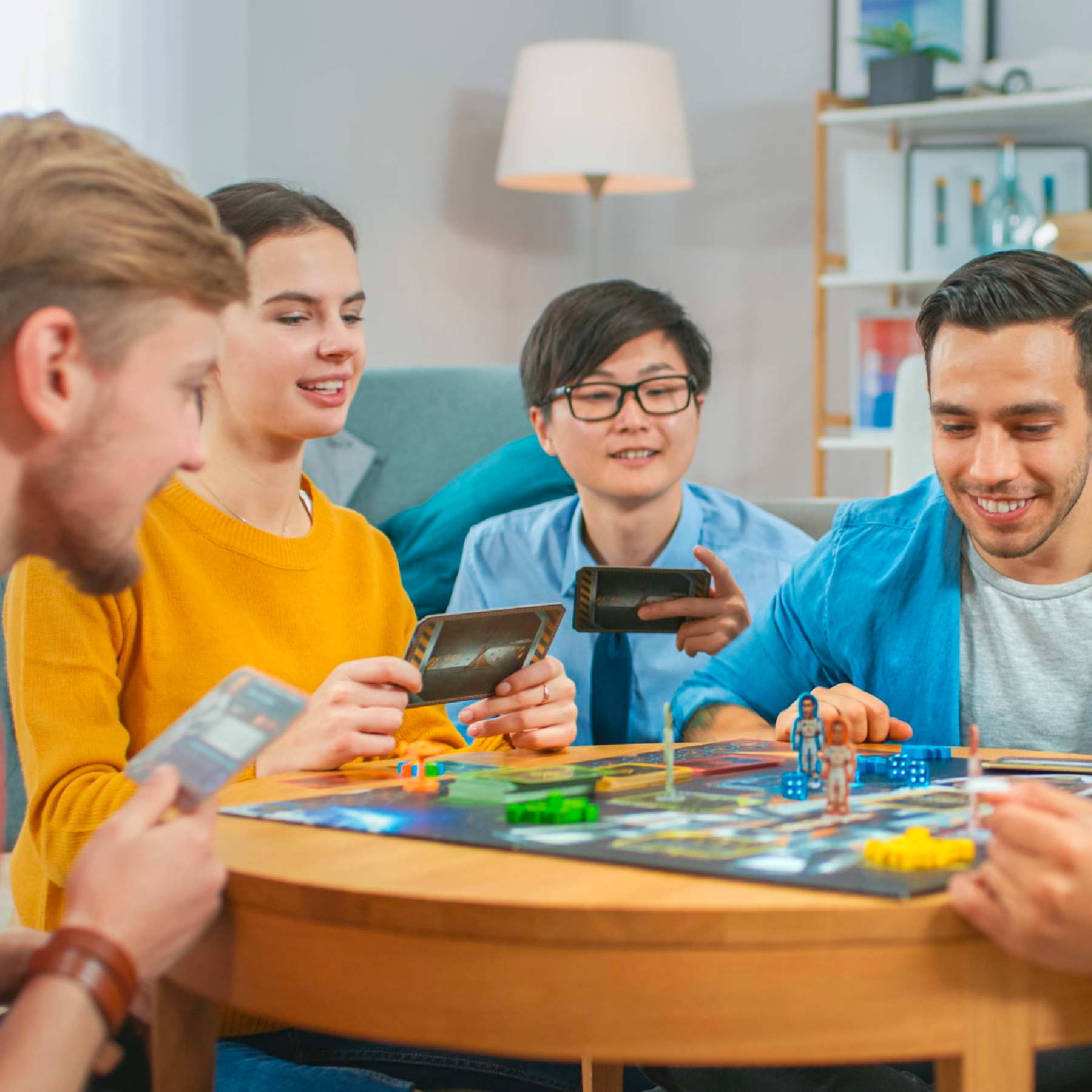 Teens at a table playing a boardgame