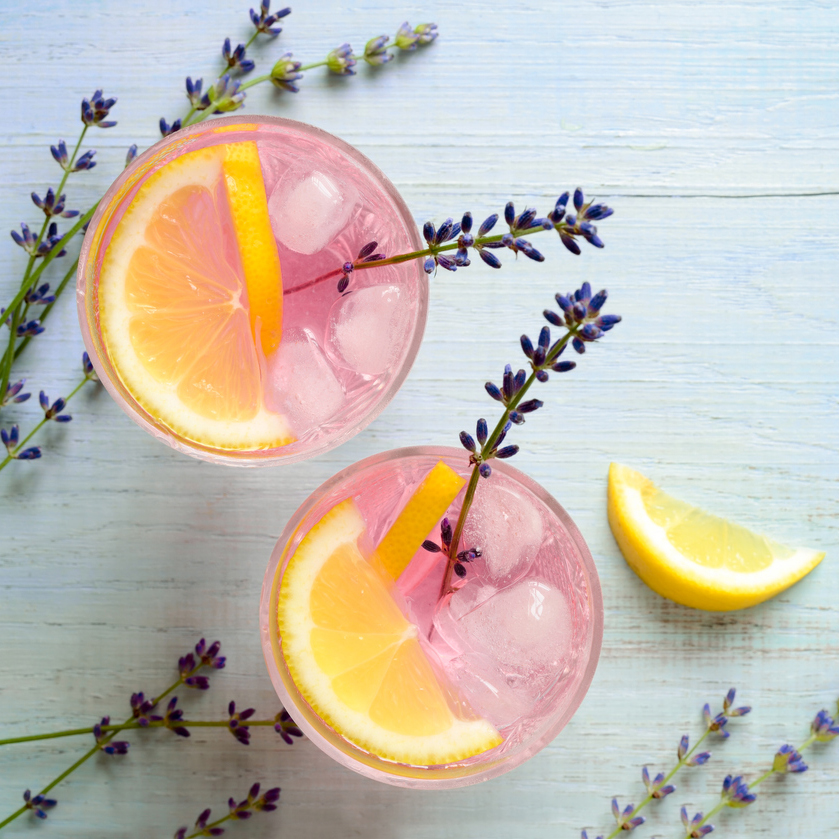 Two pink mocktails with orange and lavender