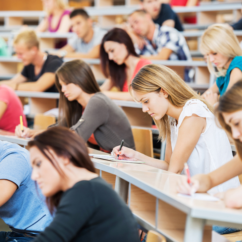Students taking a test in a large lecture hall