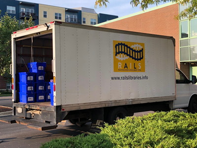 Box truck with blue bins inside