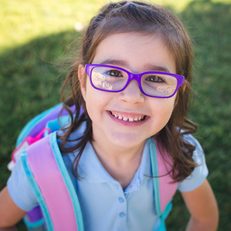 Child wearing glasses and a backpack