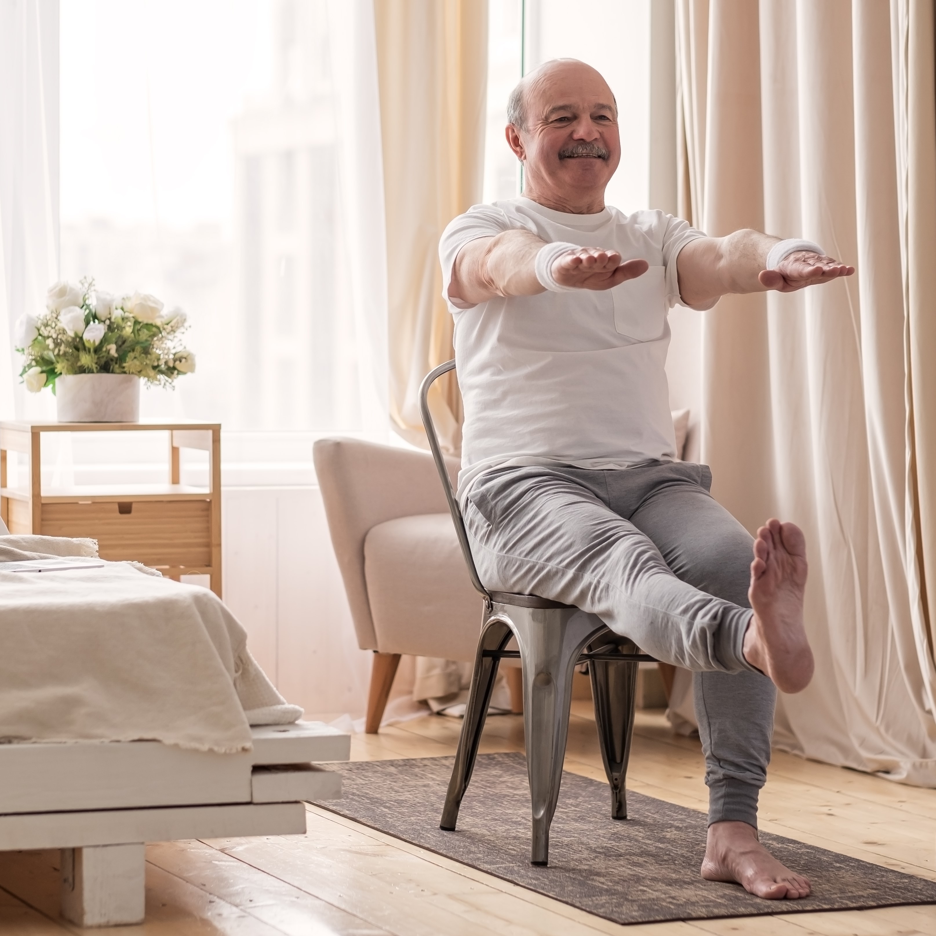 Older man doing chair exercises