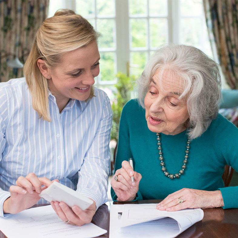 Woman assisting senior with documents