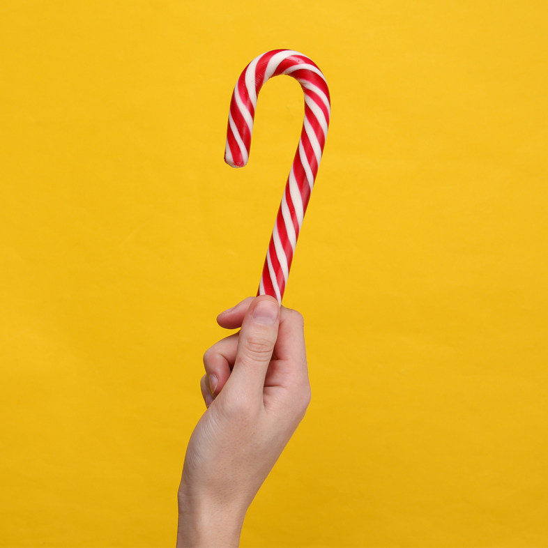 Hand holding candy cane