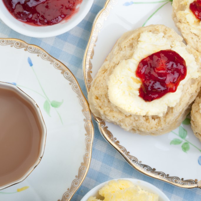 Tea and biscuit with butter and jam