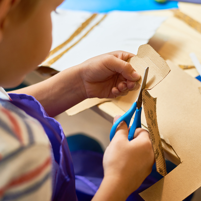 Child cutting cardboard