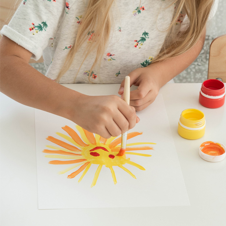 Student painting a sun