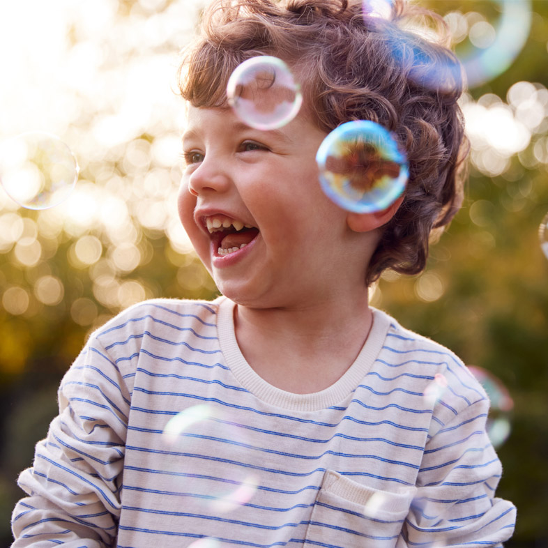 Little boy playing with bubbles