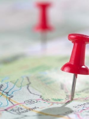 Two red push pins on a paper map
