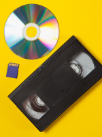VHS, DVD, and SD card on a yellow background