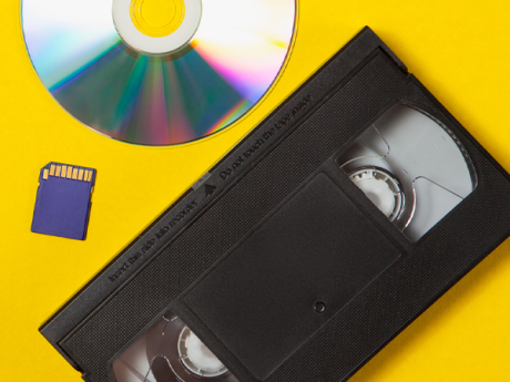 VHS, DVD, and SD card on a yellow background