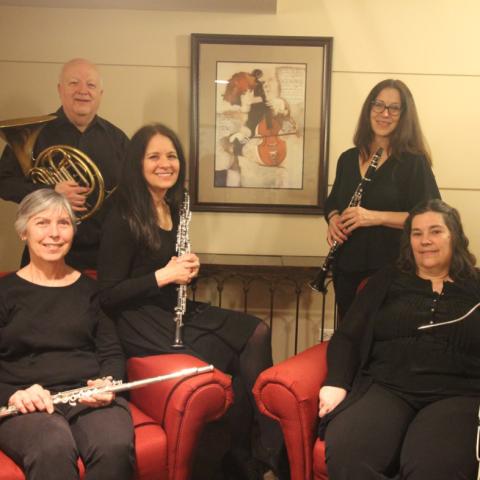 DSO Woodwind Quintet members sitting in chairs