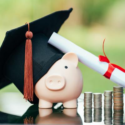 Piggy bank with graduation cap and diploma