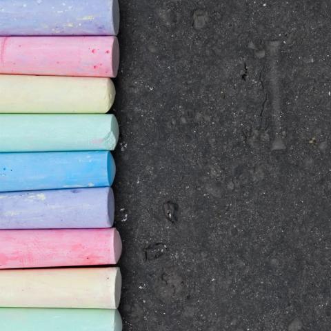 Chalk lined up on a blacktop