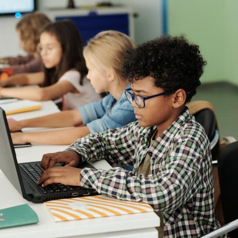 Child typing on computer