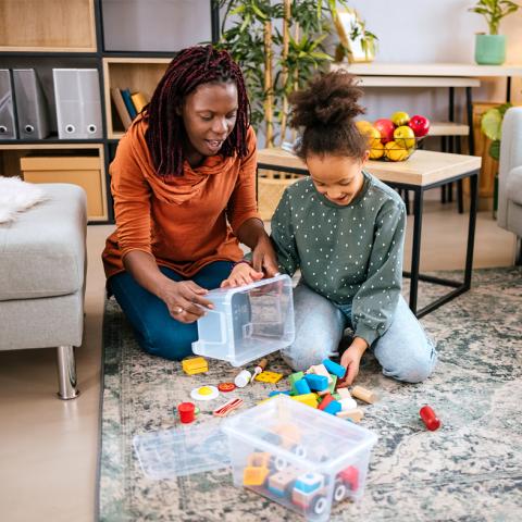 Mom and daughter picking up toys