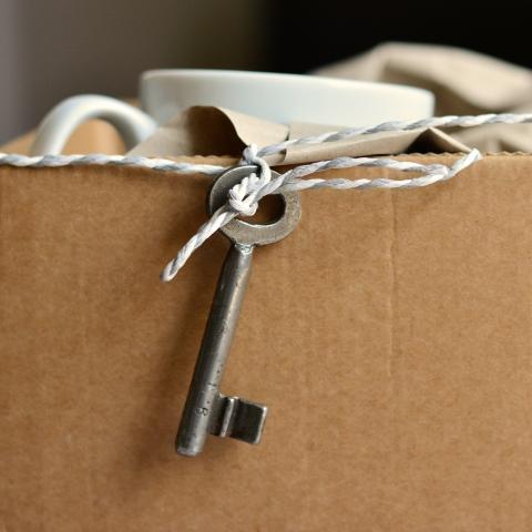 Box, packing paper, mug and key