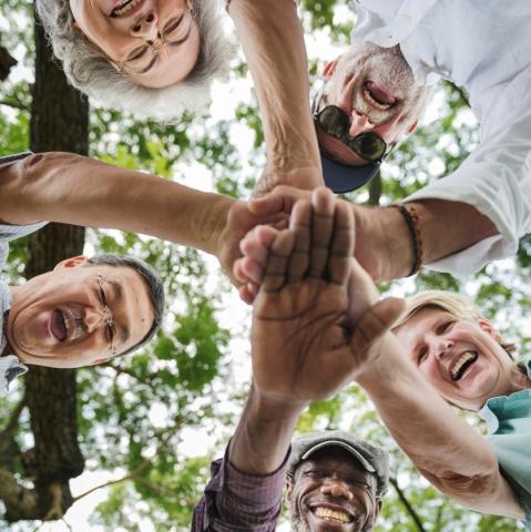 Older adults joining hands