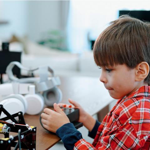 Child playing with robot