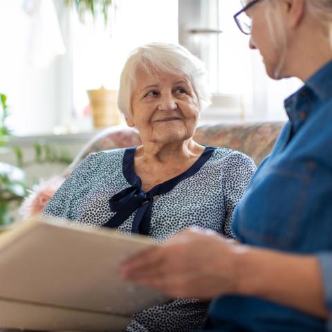 Senior being read to by caregiver