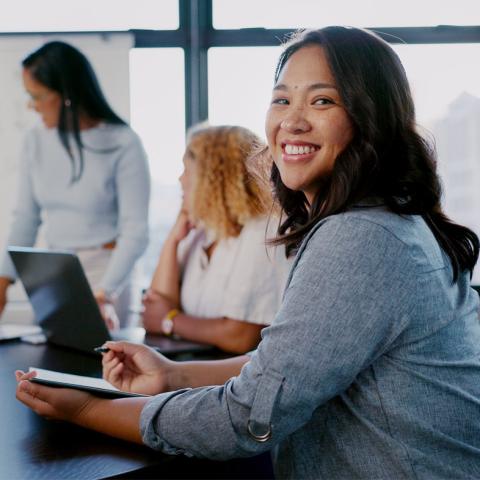 Woman in meeting smiling