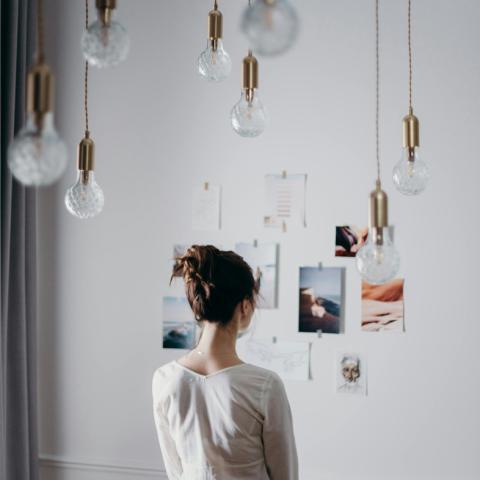 woman looking at wall collage