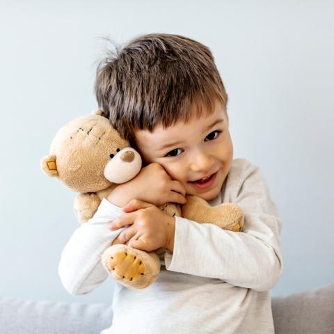 Young boy holding teddy bear