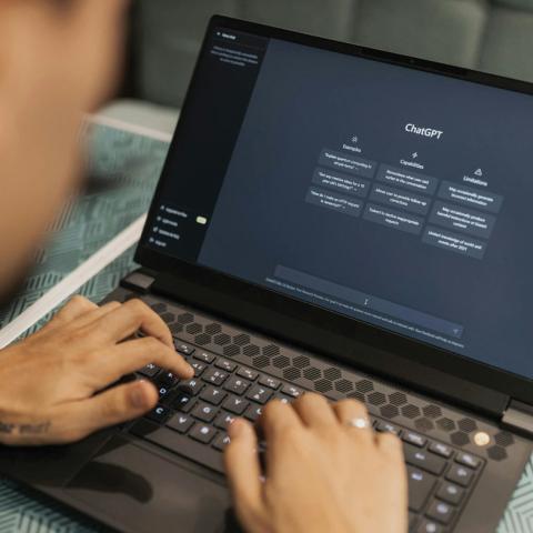 Person using chat gpt on laptop