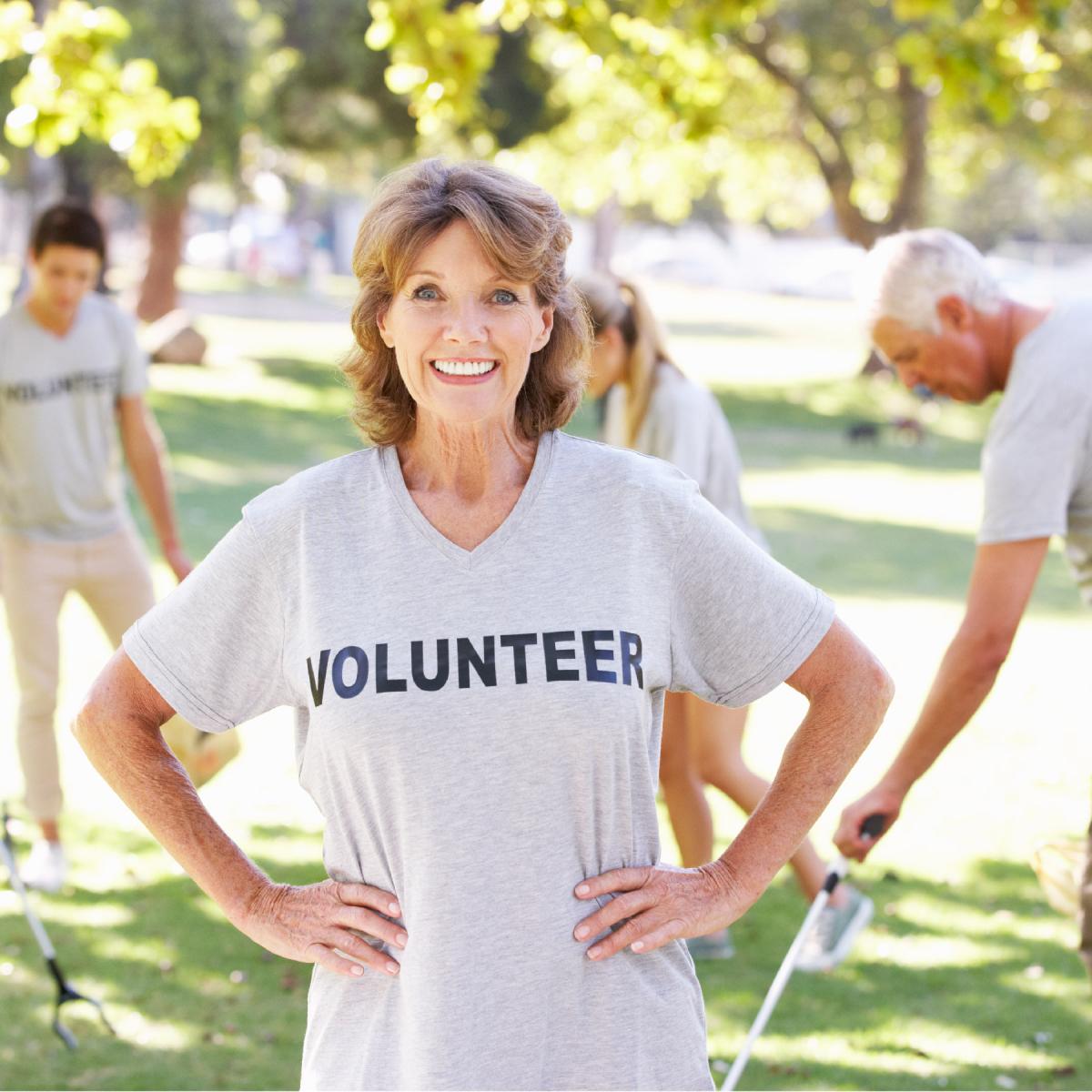 Volunteer smiling with hands on their hips