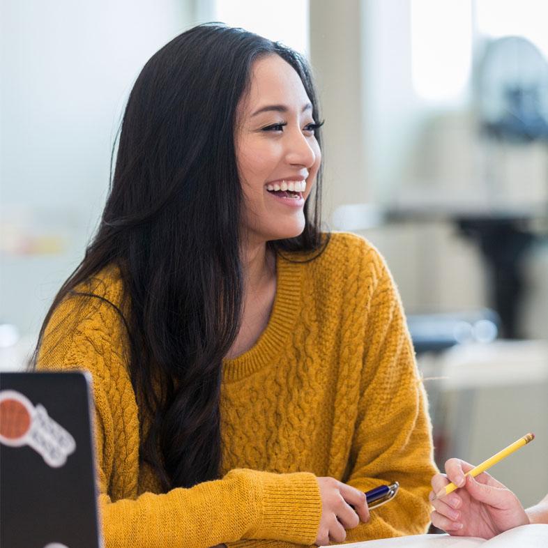 Teen laughing while studying