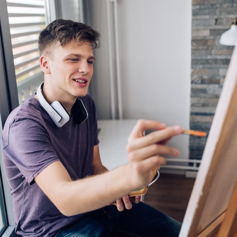 Teen painting a canvas