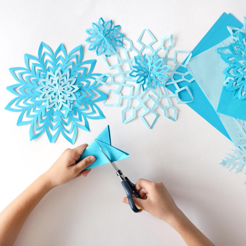 Paper snowflakes being cut
