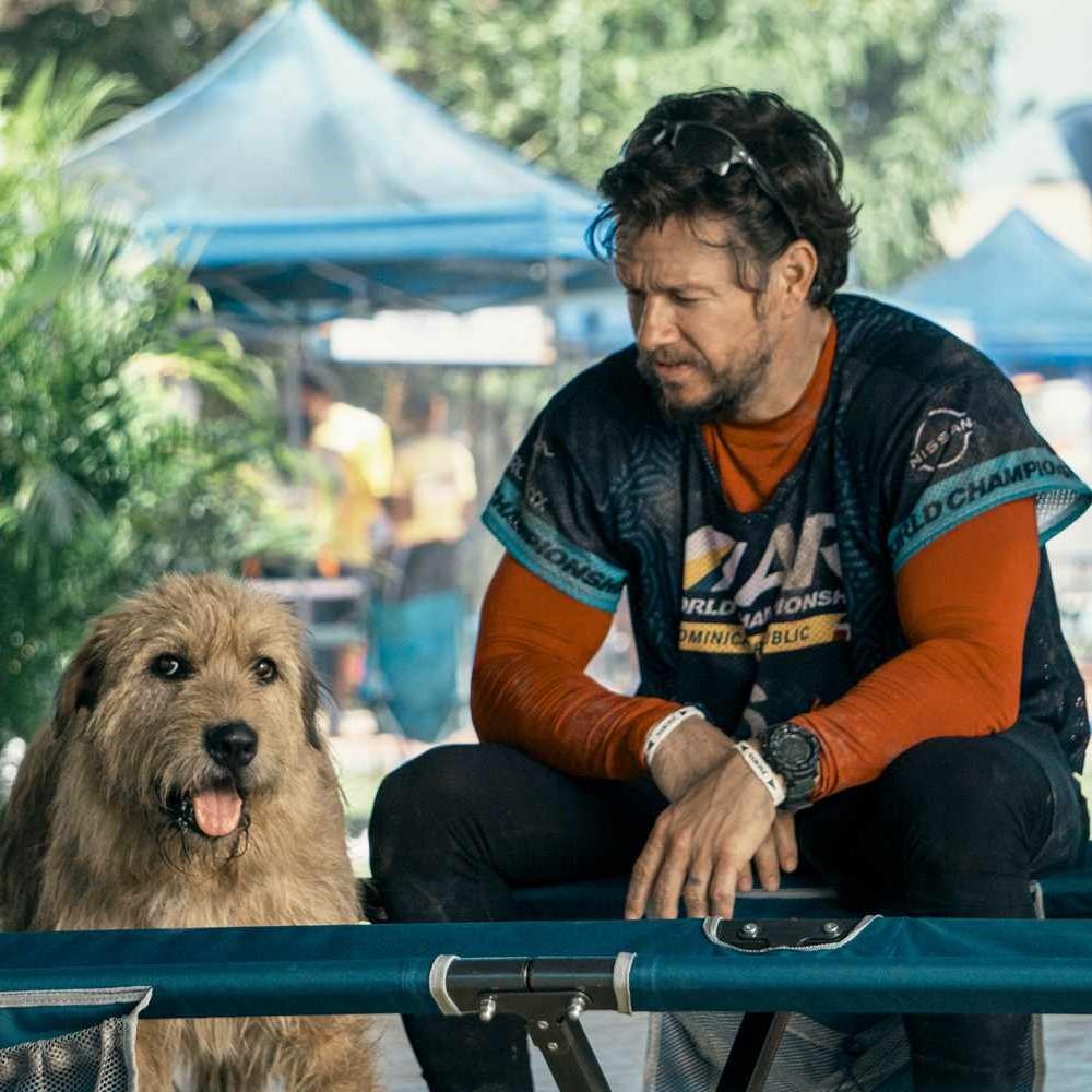 Exhausted athlete looking at panting dog