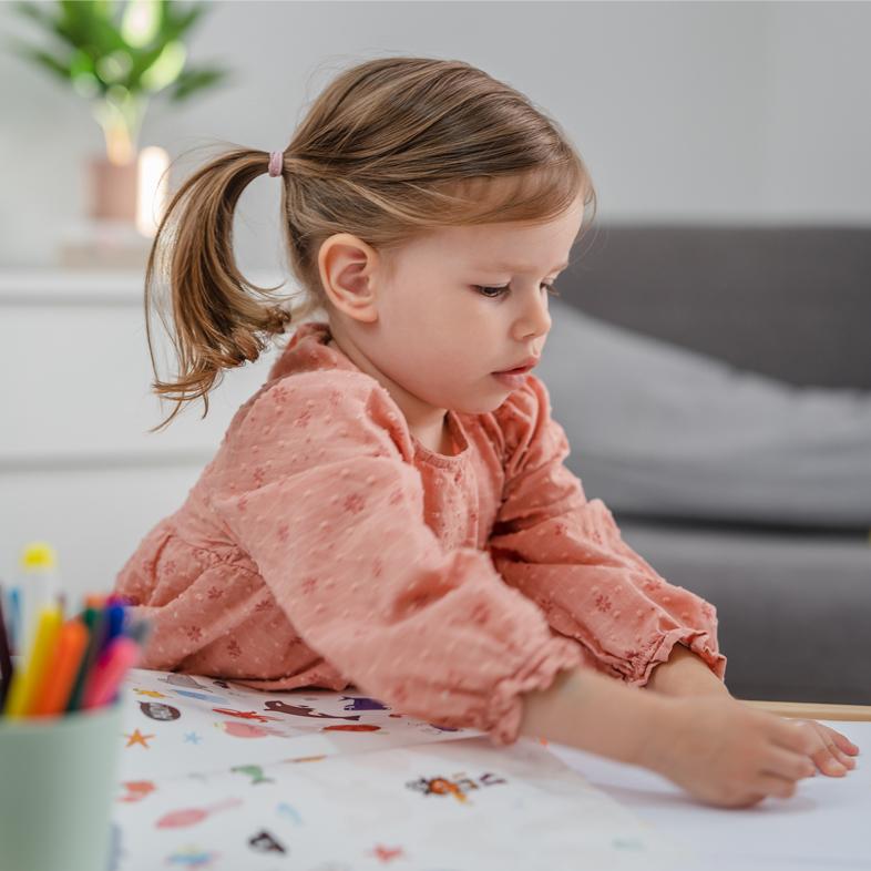 Toddler girl using stickers