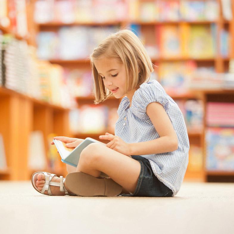 Girl sitting on floor reading