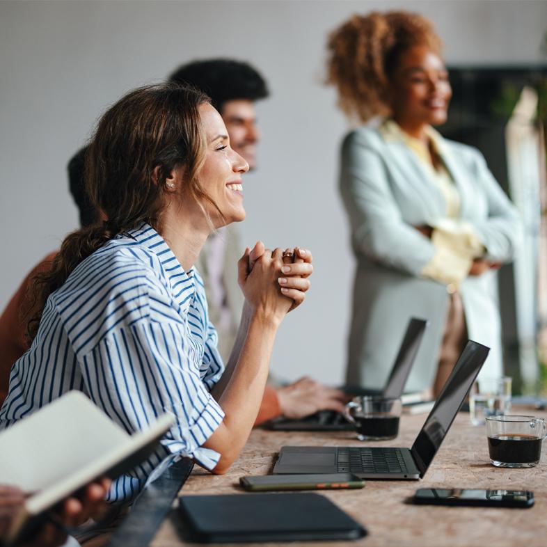 Woman smiling at board meeting