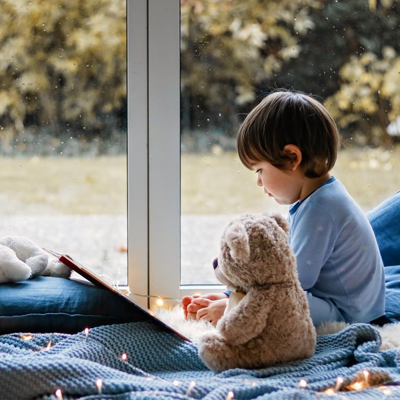 Child in pajamas reading