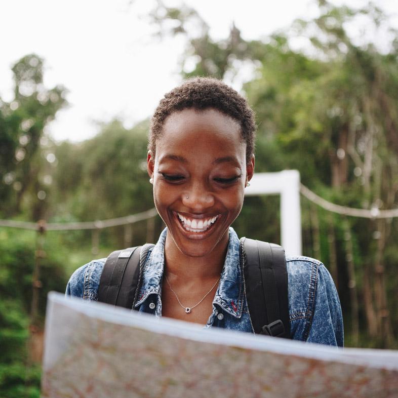 Woman looking at a map and smiling