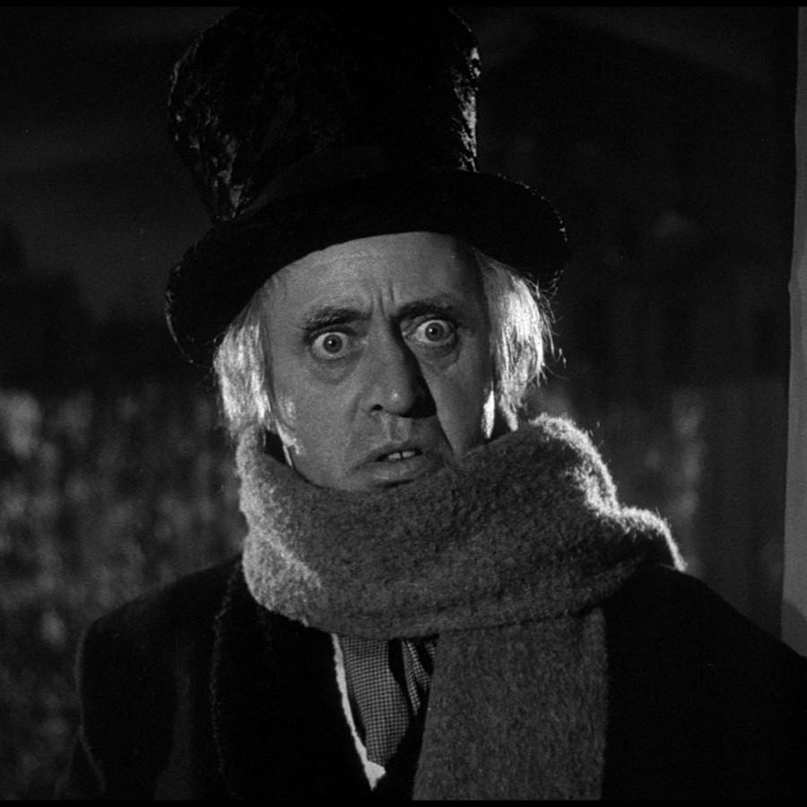 b/w image of actor Alastair Sim portraying Scrooge