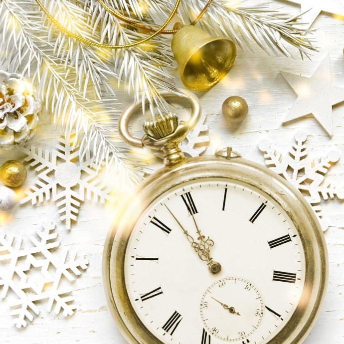 pocket watch showing time near midnight and NYE decorations