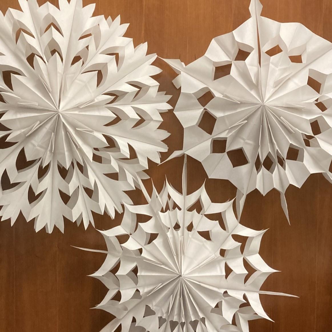 giant paper snowflakes made from white lunch sacks