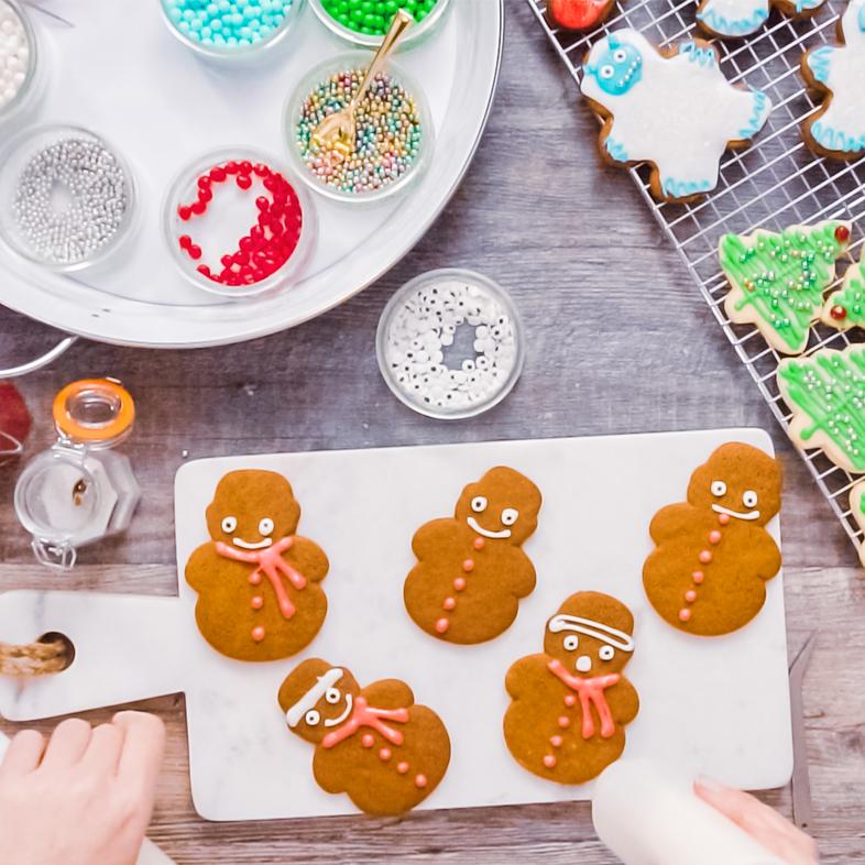 Gingerbread cookies being decorated