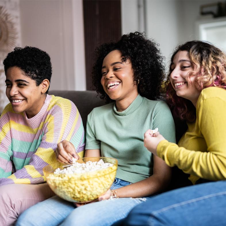 Friends sharing popcorn