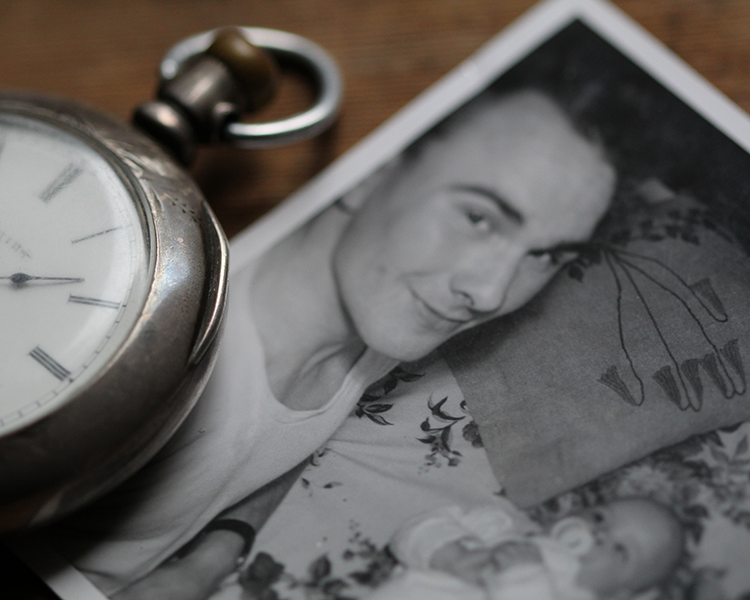 Black and white photo of dad and baby and pocket watch