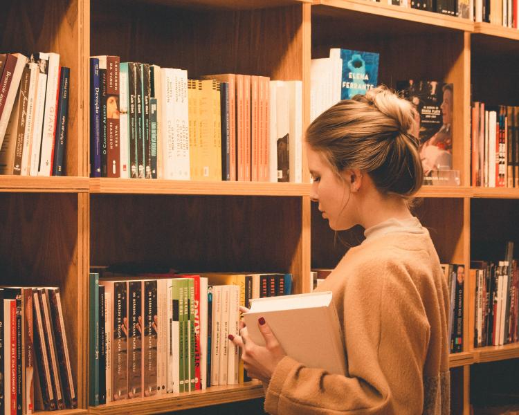 Teen looking at bookshelves